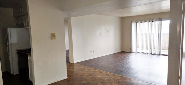 interior space with parquet floors and baseboards