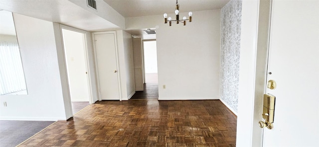interior space featuring an inviting chandelier, baseboards, and visible vents