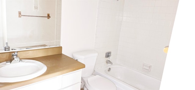 bathroom with toilet, vanity, and  shower combination