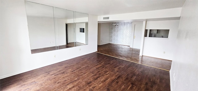 empty room featuring visible vents and wood finished floors