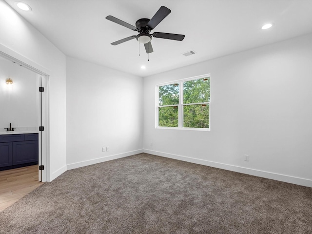 1130 Miller Rd, Sealy, TX 77474 - empty room featuring ceiling fan, light colored carpet, recessed lighting, a sink, and baseboards