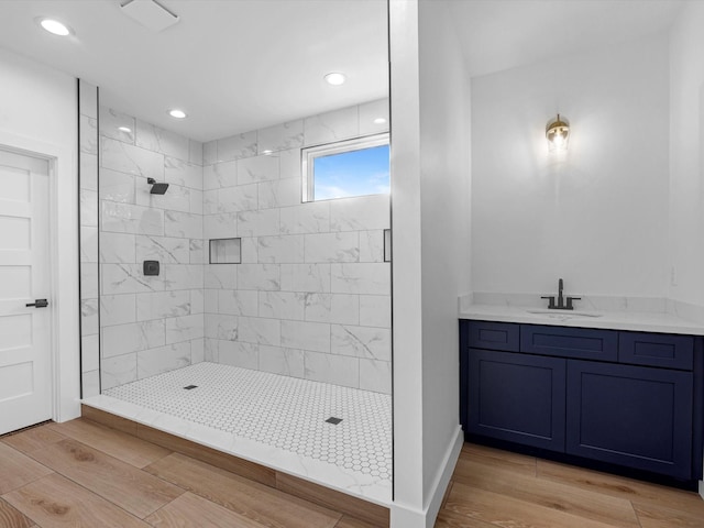 1130 Miller Rd, Sealy, TX 77474 - bathroom featuring recessed lighting, tiled shower, vanity, and wood finished floors