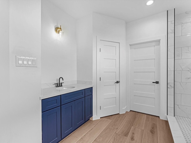 1130 Miller Rd, Sealy, TX 77474 - bathroom with recessed lighting, vanity, and wood finished floors