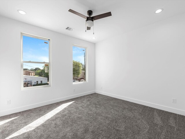 1130 Miller Rd, Sealy, TX 77474 - spare room featuring dark carpet, visible vents, baseboards, and a ceiling fan