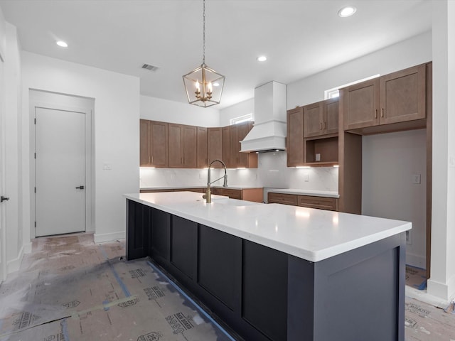 1130 Miller Rd, Sealy, TX 77474 - kitchen featuring visible vents, a sink, premium range hood, a kitchen island with sink, and pendant lighting