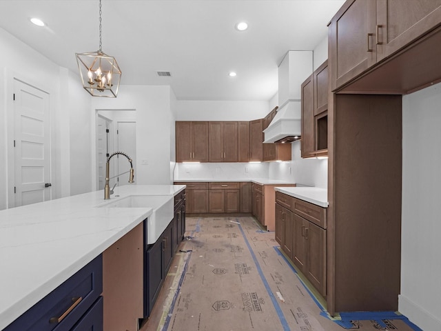 1130 Miller Rd, Sealy, TX 77474 - kitchen featuring visible vents, an inviting chandelier, a sink, recessed lighting, and light stone counters