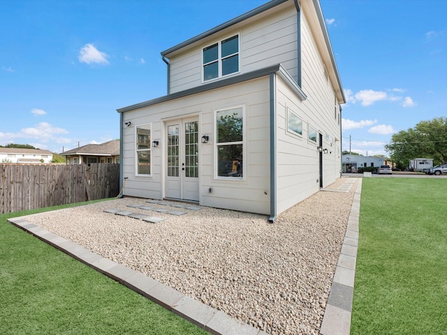 1130 Miller Rd, Sealy, TX 77474 - back of property featuring french doors, fence, and a lawn
