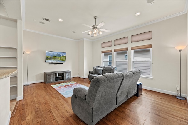5329 Kansas St, Houston, TX 77007 - living area featuring baseboards, ornamental molding, visible vents, ceiling fan, and wood finished floors