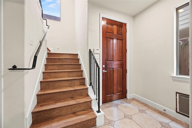 5329 Kansas St, Houston, TX 77007 - foyer with light tile patterned flooring, baseboards, and stairs