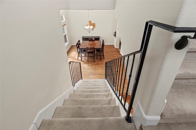 5329 Kansas St, Houston, TX 77007 - staircase featuring baseboards, a chandelier, and wood finished floors