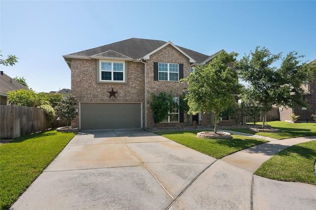 view of front facade with a front yard, fence, brick siding, an attached garage, and driveway