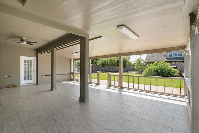 view of patio / terrace with ceiling fan and fence
