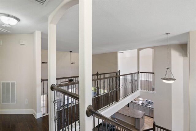 13315 Edison Trace Ln, Tomball, TX 77377 - hall featuring baseboards, arched walkways, visible vents, and wood finished floors