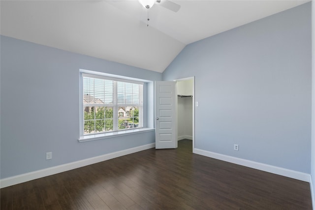 unfurnished bedroom with a closet, baseboards, a ceiling fan, dark wood-type flooring, and lofted ceiling