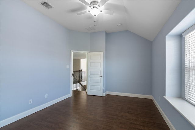 unfurnished bedroom featuring dark wood-style flooring, baseboards, a ceiling fan, visible vents, and lofted ceiling