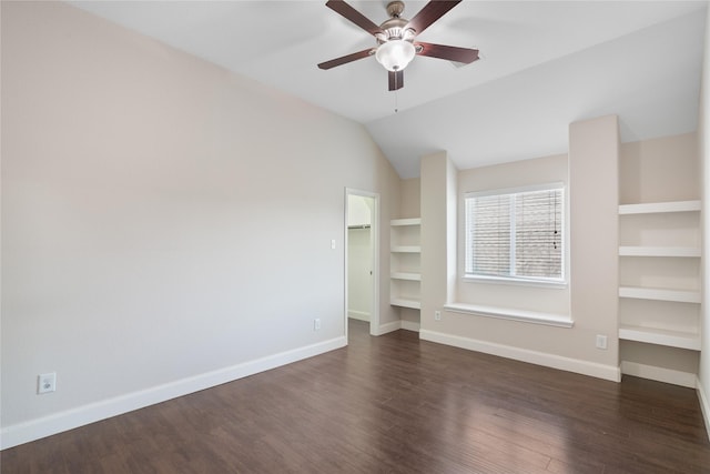 unfurnished room with baseboards, ceiling fan, and dark wood finished floors