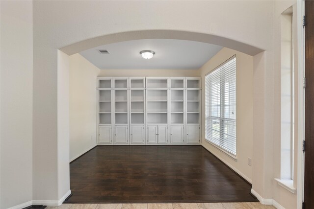 13315 Edison Trace Ln, Tomball, TX 77377 - spare room featuring visible vents, wood finished floors, and arched walkways