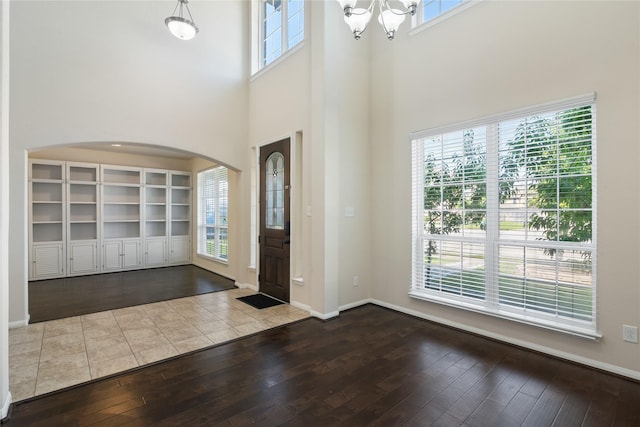 13315 Edison Trace Ln, Tomball, TX 77377 - entrance foyer featuring a chandelier, a high ceiling, arched walkways, and dark wood-style floors