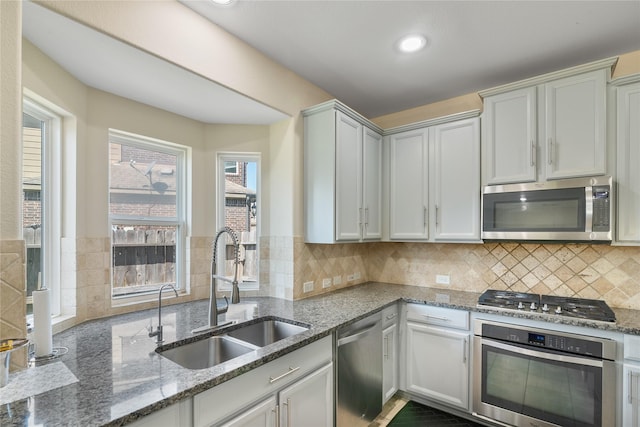 13315 Edison Trace Ln, Tomball, TX 77377 - kitchen featuring stone countertops, recessed lighting, a sink, stainless steel appliances, and tasteful backsplash