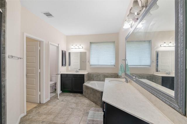 13315 Edison Trace Ln, Tomball, TX 77377 - bathroom with toilet, a sink, visible vents, and a bath
