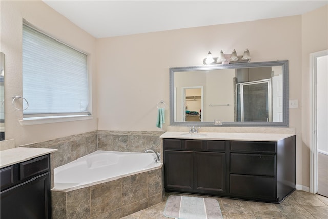13315 Edison Trace Ln, Tomball, TX 77377 - bathroom featuring a shower stall, vanity, a bath, and a walk in closet