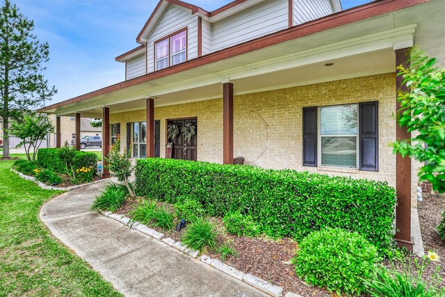 3026 Dees Cir, Sealy, TX 77474 - view of front facade with brick siding and covered porch