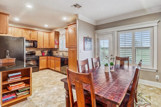 3026 Dees Cir, Sealy, TX 77474 - kitchen with black appliances, dark countertops, decorative backsplash, and plenty of natural light