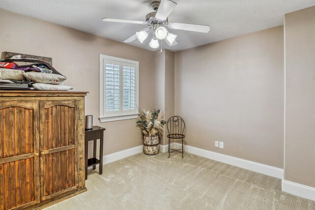 3026 Dees Cir, Sealy, TX 77474 - sitting room featuring a ceiling fan, carpet flooring, a textured ceiling, and baseboards