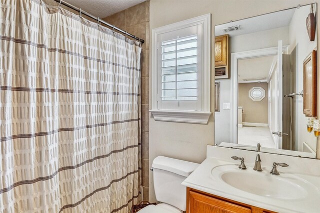 3026 Dees Cir, Sealy, TX 77474 - bathroom with a wealth of natural light, toilet, visible vents, and vanity