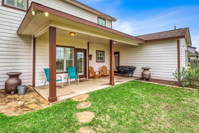 3026 Dees Cir, Sealy, TX 77474 - back of property featuring a shingled roof, a yard, and a patio area
