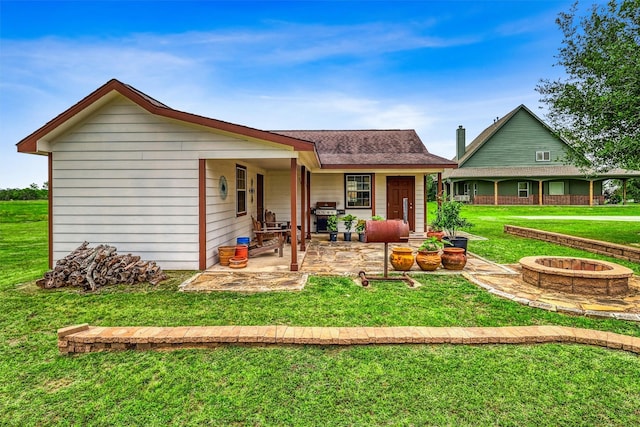 3026 Dees Cir, Sealy, TX 77474 - rear view of property with a lawn, a patio area, and a fire pit