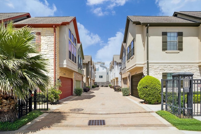 view of road with a residential view and driveway