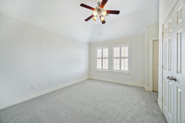unfurnished bedroom featuring a ceiling fan, carpet flooring, lofted ceiling, and baseboards