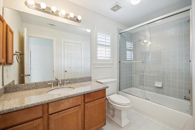 full bathroom with toilet, vanity, visible vents, and tile patterned floors