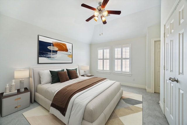 carpeted bedroom featuring ceiling fan, vaulted ceiling, and baseboards