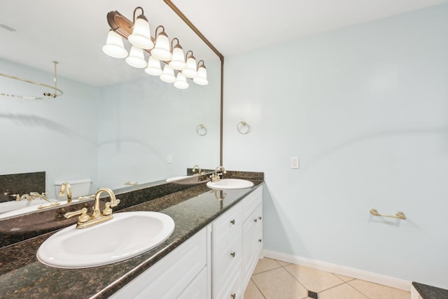 7463 Brompton St Unit 7463, Houston, TX 77025 - bathroom with double vanity, tile patterned flooring, and baseboards