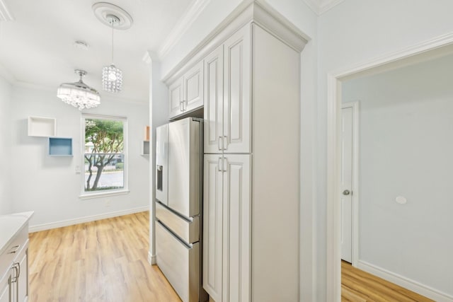 7463 Brompton St Unit 7463, Houston, TX 77025 - kitchen with refrigerator with ice dispenser, ornamental molding, light wood-style flooring, baseboards, and a chandelier