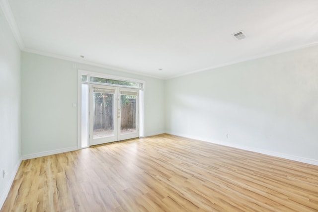 7463 Brompton St Unit 7463, Houston, TX 77025 - empty room featuring crown molding, light wood finished floors, baseboards, and french doors