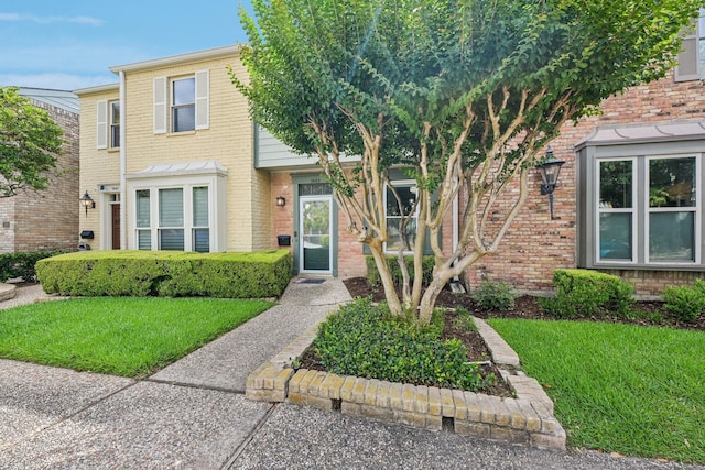 7463 Brompton St Unit 7463, Houston, TX 77025 - view of front facade with brick siding and a front yard