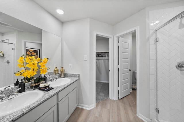 full bathroom featuring a shower stall, a sink, and visible vents