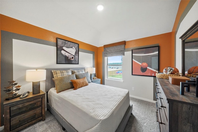 bedroom with carpet floors, baseboards, and lofted ceiling