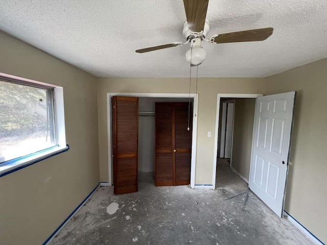unfurnished bedroom featuring a textured ceiling, a closet, and a ceiling fan