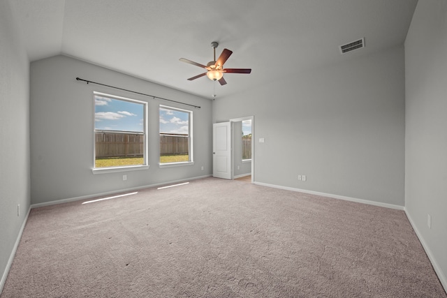 spare room with visible vents, baseboards, a ceiling fan, carpet, and lofted ceiling
