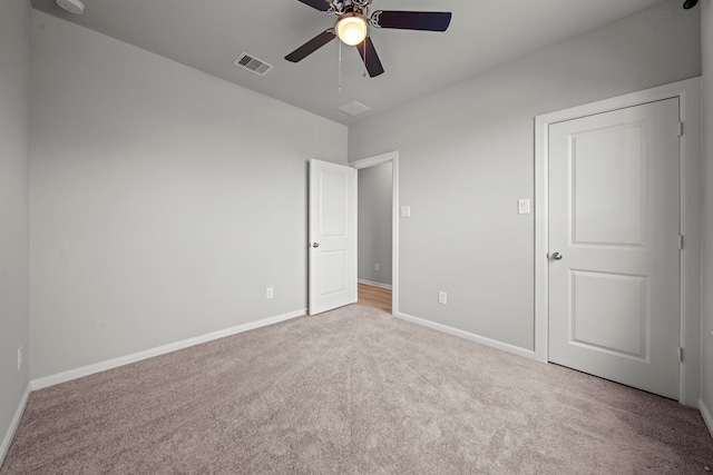 unfurnished bedroom featuring visible vents, baseboards, carpet flooring, and ceiling fan