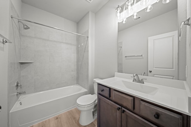 full bathroom with vanity, toilet, visible vents, bathtub / shower combination, and wood finished floors
