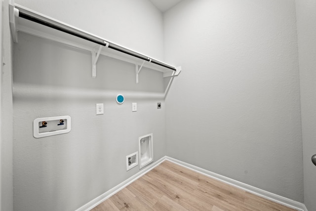 washroom with hookup for an electric dryer, light wood-type flooring, gas dryer hookup, laundry area, and hookup for a washing machine