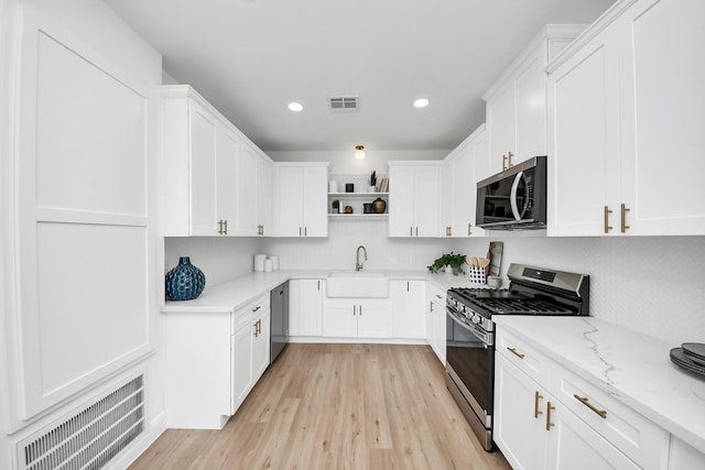 300 Narcissus Rd, Clear Lake Shores, TX 77565 - kitchen featuring visible vents, a sink, open shelves, and appliances with stainless steel finishes