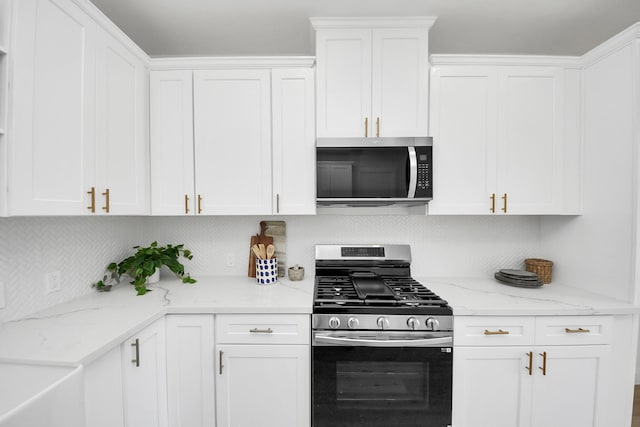 300 Narcissus Rd, Clear Lake Shores, TX 77565 - kitchen with appliances with stainless steel finishes, decorative backsplash, and white cabinets