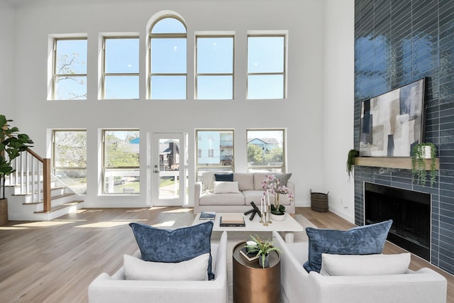 300 Narcissus Rd, Clear Lake Shores, TX 77565 - living area with a high ceiling, a tiled fireplace, and a healthy amount of sunlight