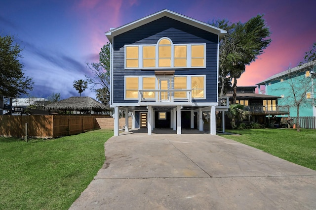 300 Narcissus Rd, Clear Lake Shores, TX 77565 - coastal inspired home with a carport, driveway, fence, and a front yard